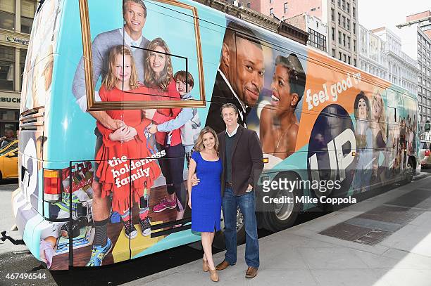 Kim Holderness and husband Penn Holderness pose for a picture at Up Tv's "The Holderness Family" Photo Call on March 25, 2015 in New York City.