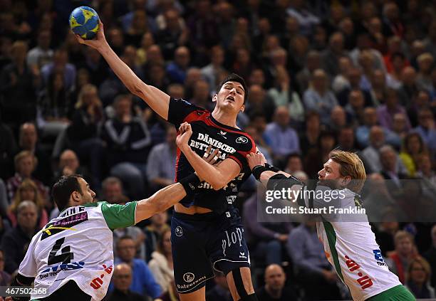 Drasko Nenadic of Flensburg is challenged by Manuel Späth of Goeppingen during the DKB Bundesliga handball match between SG Flensburg-Handewitt and...