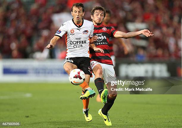 Liam Miller of the Roar is challenged by Mateo Poljak of the Wanderers during the round 18 A-League match between the Western Sydney Wanderers and...