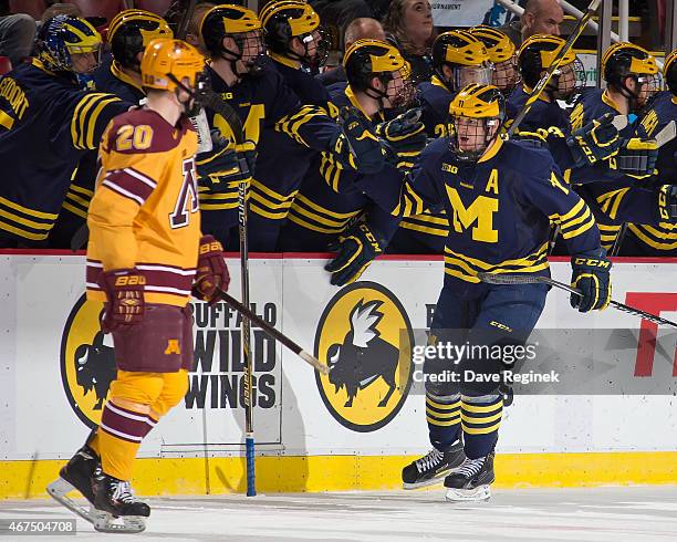Zach Hyman of the Michigan Wolverines celebrates his goal with teammates against the Minnesota Golden Gophers during the finals of Big Ten Mens Ice...