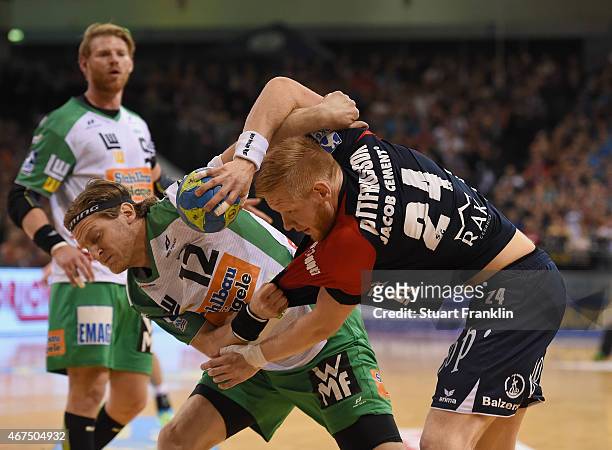 Jim Gottfridsson of Flensburg is challenged by Felix Lobedank of Goeppingen during the DKB Bundesliga handball match between SG Flensburg-Handewitt...
