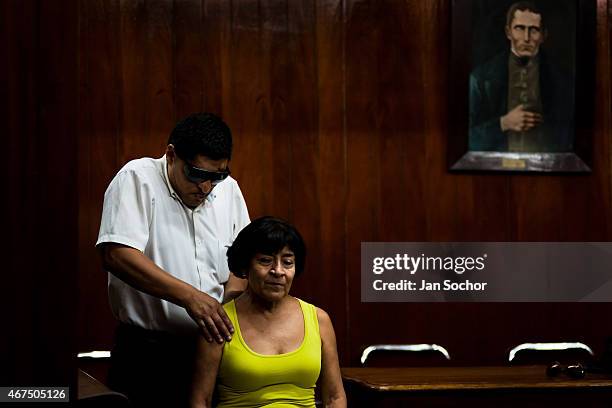 Blind man massages a client's back at Unión Nacional de Ciegos del Perú, a social club for the visually impaired on April 03, 2013 in Lima. Unión...