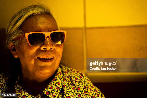Blind woman poses for a picture in the foyer of Unión Nacional de Ciegos del Perú, a social club for the visually impaired on April 05, 2013 in Lima....