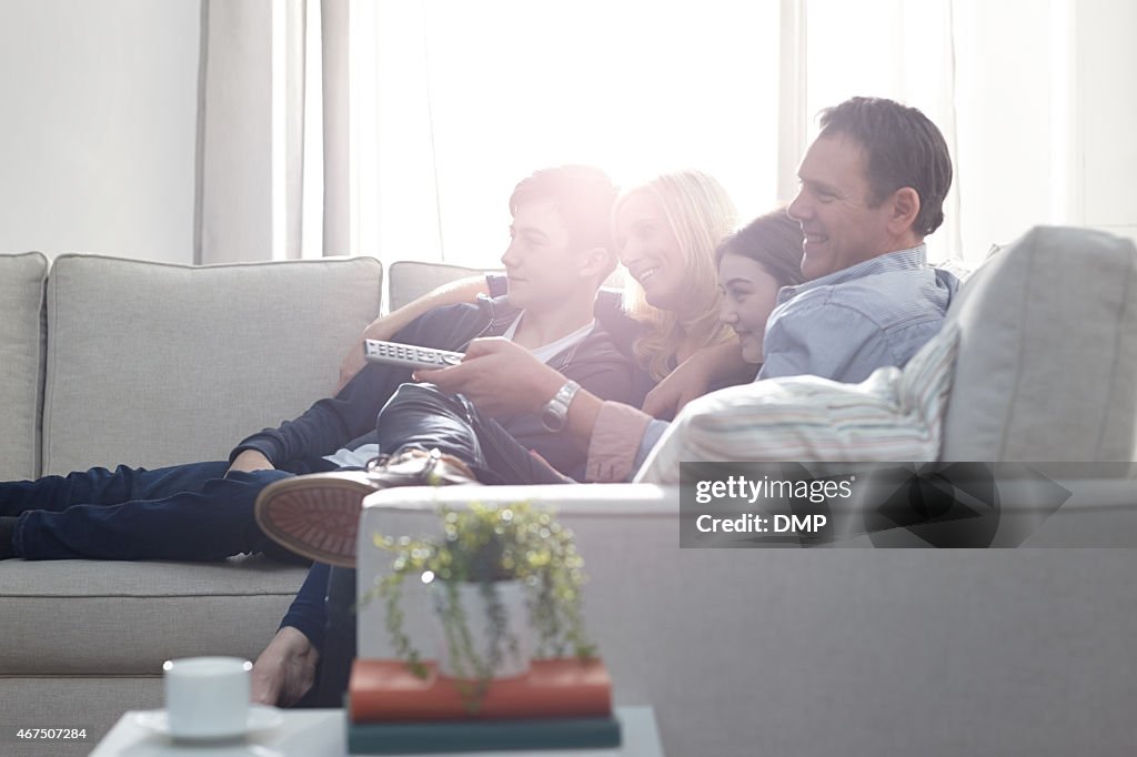 Family watching television at home