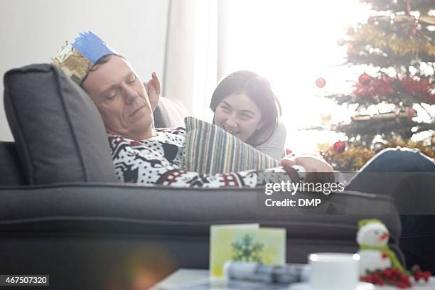 little girl trying to awaken her father - after party living room stock pictures, royalty-free photos & images