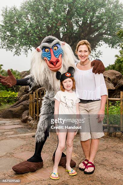 In this handout photo provided by Disney Parks, actress Edie Falco, and her daughter Macy pose with Rafiki at Disney's Animal Kingdom theme park...