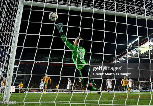 Goalkeeper Ron-Robert Zieler of Germany dives in vain as Mile Jedinak of Australia scores his team's second goal from a free kick during the...
