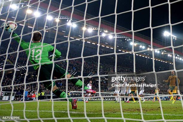 Goalkeeper Ron-Robert Zieler of Germany dives in vain as Mile Jedinak of Australia scores his team's second goal from a free kick during the...