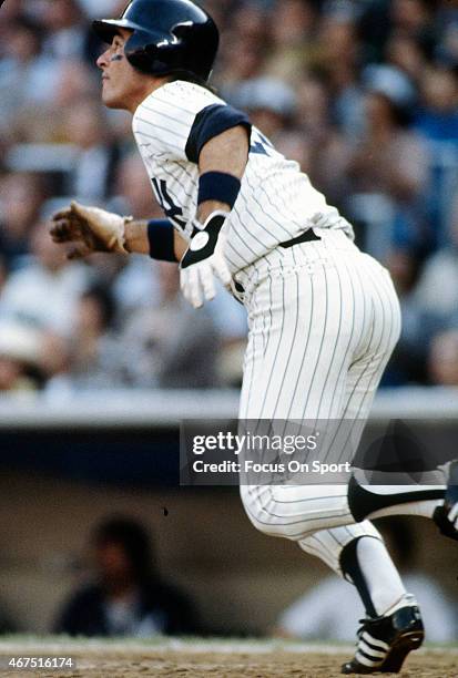 Bucky Dent of the New York Yankees watches the flight of his ball as he runs towards first base during an Major League Baseball game circa 1979 at...