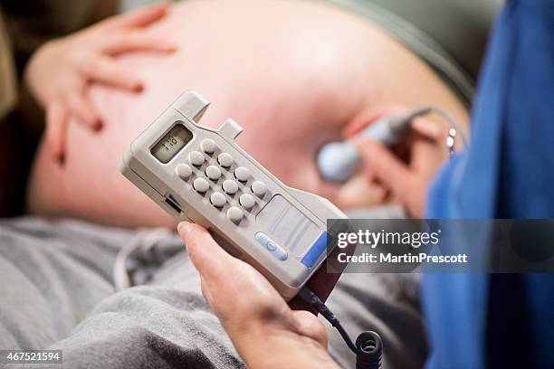 midwife measuring patients foetal heart sounds on audio dopplex - fetus heart stock pictures, royalty-free photos & images