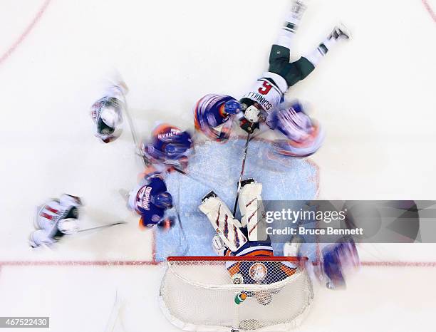 Jaroslav Halak and the New York Islanders defend against the Minnesota Wild at the Nassau Veterans Memorial Coliseum on March 24, 2015 in Uniondale,...