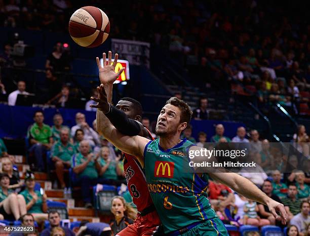 Mitch Norton of the Crocodiles contests the ball with James Ennis of the Wildcats during the round 17 NBL match between the Townsville Crocodiles and...