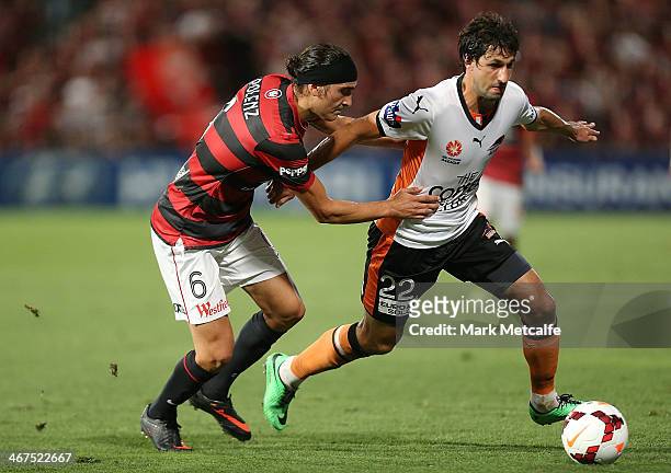 Thomas Broich of the Roar is challenged by Jerome Polenz of the Wanderers during the round 18 A-League match between the Western Sydney Wanderers and...