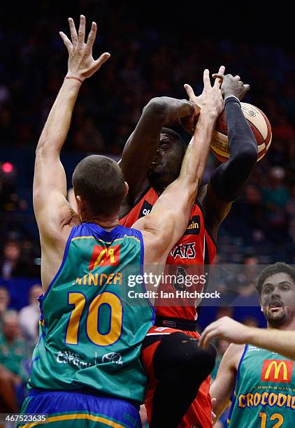 James Ennis of the Wildcats is blocked by Russell Hinder of the Crocodiles during the round 17 NBL match between the Townsville Crocodiles and the...