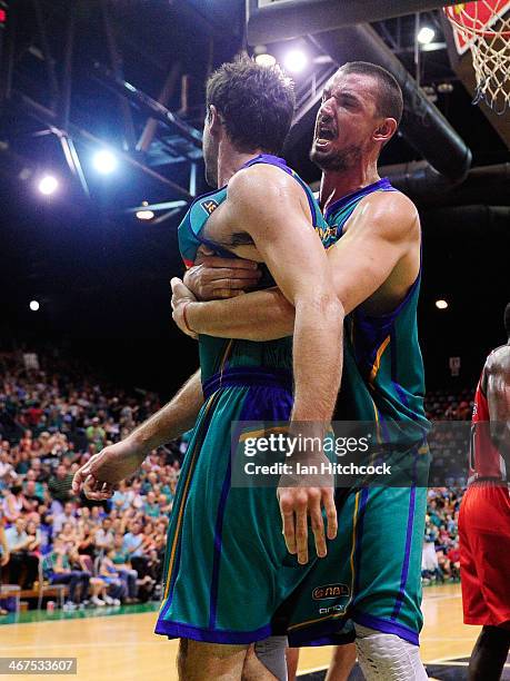 Russell Hinder of the Crocodiles embraces Todd Blanchfield during the round 17 NBL match between the Townsville Crocodiles and the Perth Wildcats at...