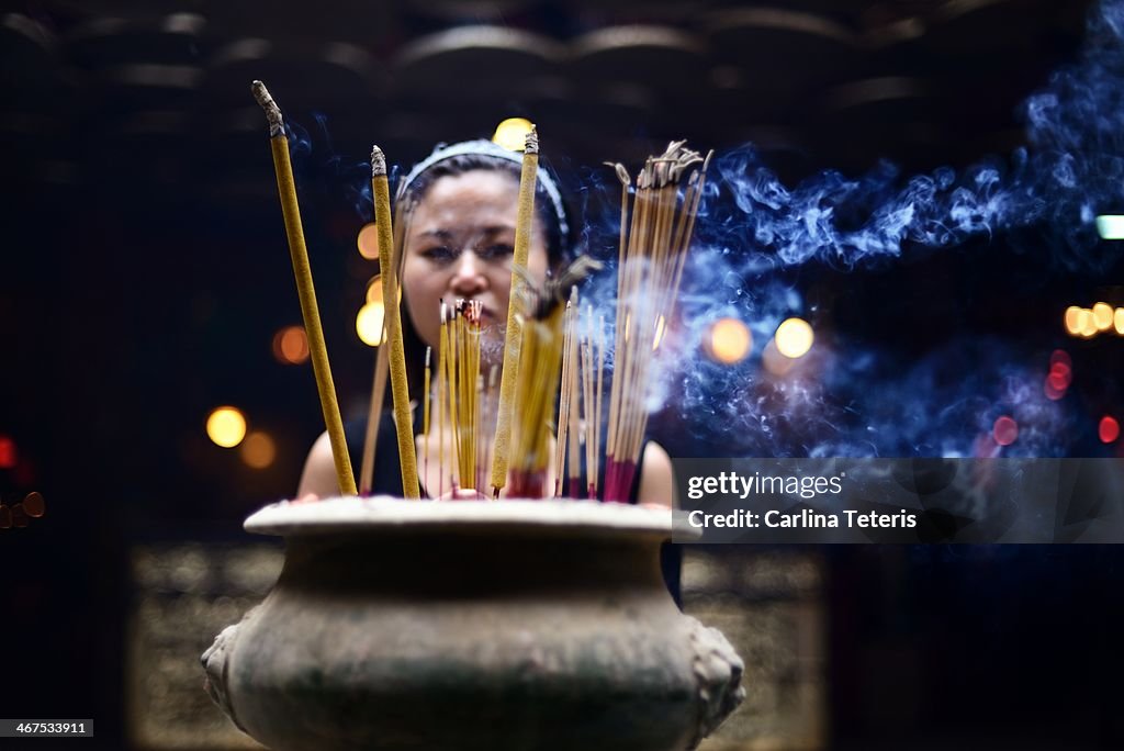 Woman praying in a Chinese temple