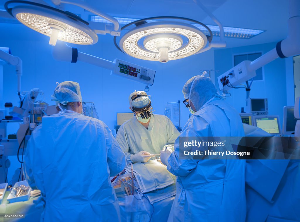 Surgeons performing open heart surgery