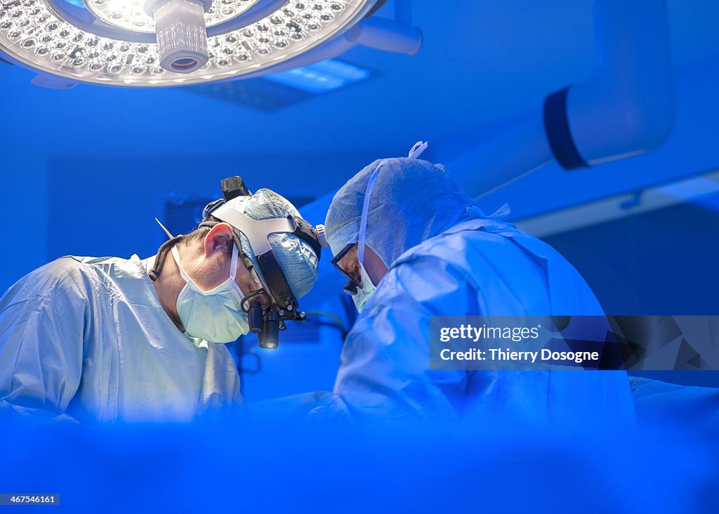 Surgeons performing open heart surgery