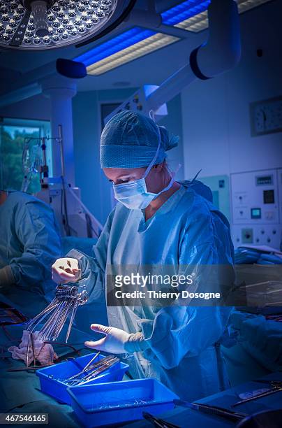 surgeon preparing surgical instruments - surgical equipment stock pictures, royalty-free photos & images