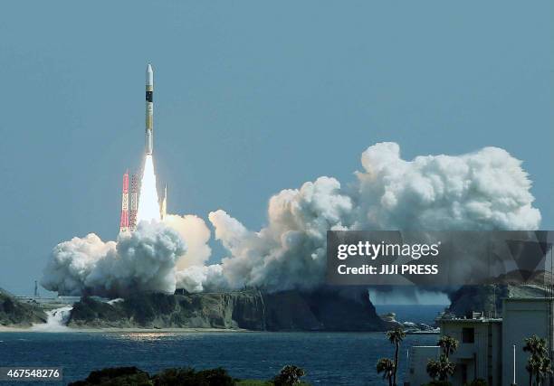 Japan's H-2A rocket carrying an information-gathering satellite lifts off from the launching pad at the Tanegashima Space Center in Tanegashima...