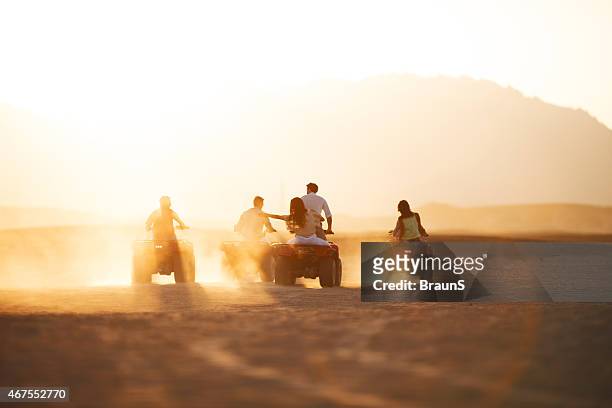 rear view of group of people driving quad bikes. - s the adventures of rin tin tin stockfoto's en -beelden