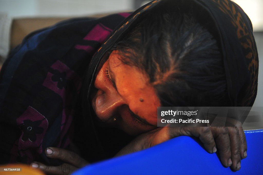 A relative of the petrol bomb attack cries. There were...
