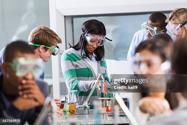 students doing experiment in chemistry class - college student diverse stock pictures, royalty-free photos & images