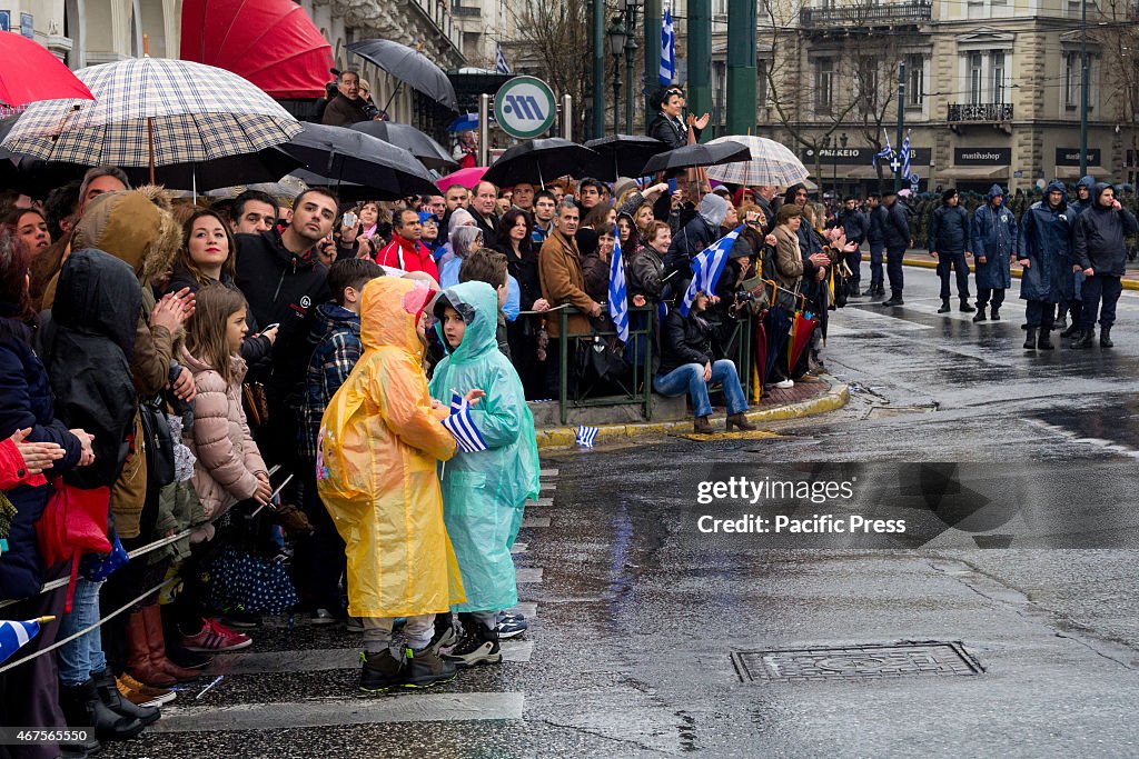 Many people watch the parade. The anniversary of Greece's...