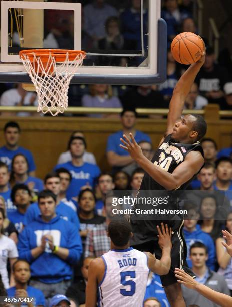 Travis McKie of the Wake Forest Demon Deacons dunks over Rodney Hood of the Duke Blue Devils during their game at Cameron Indoor Stadium on February...
