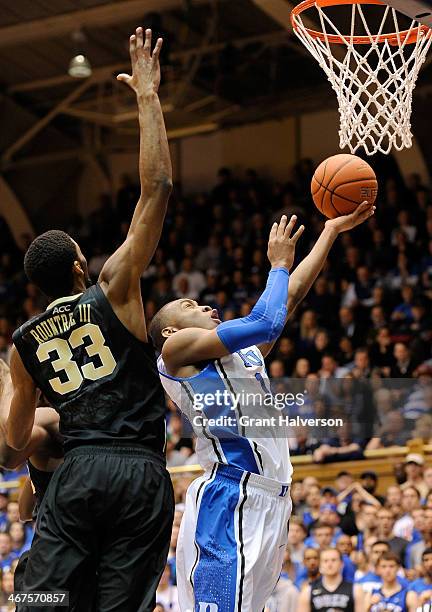 Rasheed Sulaimon of the Duke Blue Devils drives to the basket against Aaron Rountree III of the Wake Forest Demon Deacons during their game at...