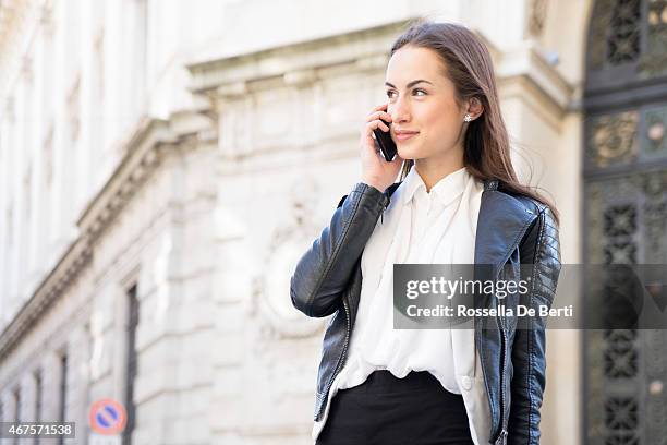 successful businesswoman on the phone in urban landscape - conservative politics stock pictures, royalty-free photos & images