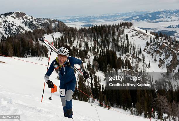 Ski mountaineering racer charging up the Headwall at Jackson Hole Mountain Resort during the 2012 National's. He is wearing a spandex ski suit with...