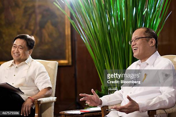 Benigno Aquino, the Philippines' president, right, speaks as Cesar Purisima, Philippines secretary of finance, listens during a Bloomberg Television...