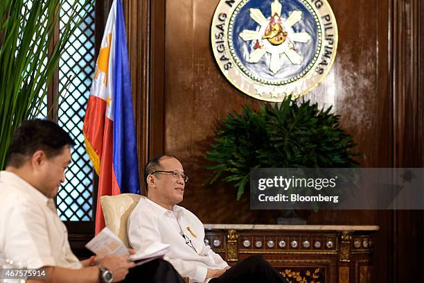 Benigno Aquino, the Philippines' president, right, and Cesar Purisima, Philippines secretary of finance, listen during a Bloomberg Television...