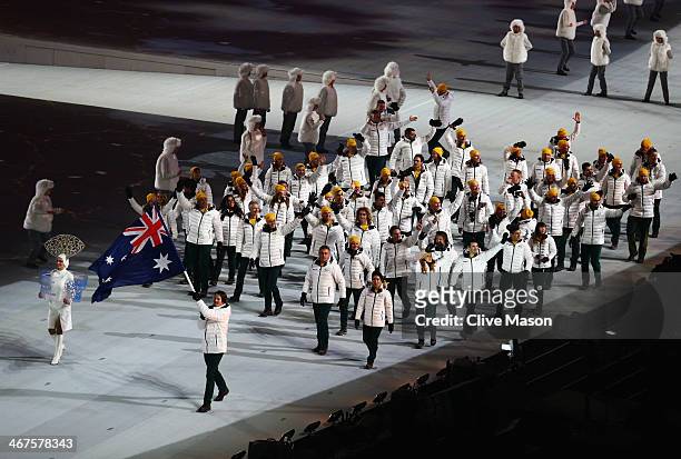 Snowboarder Alex Pullin of the Australia Olympic team carries his country's flag during the Opening Ceremony of the Sochi 2014 Winter Olympics at...