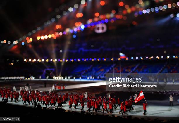 Nordic combined skier Mario Stecher of the Austria Olympic team carries his country's flag during the Opening Ceremony of the Sochi 2014 Winter...