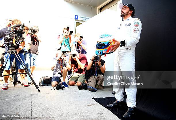 Fernando Alonso of Spain and McLaren Honda poses for photographers outside the team garage during previews to the Malaysia Formula One Grand Prix at...