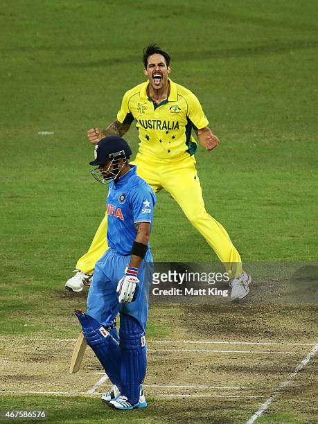Mitchell Johnson of Australia celebrates taking the wicket of Virat Kohli of India during the 2015 Cricket World Cup Semi Final match between...