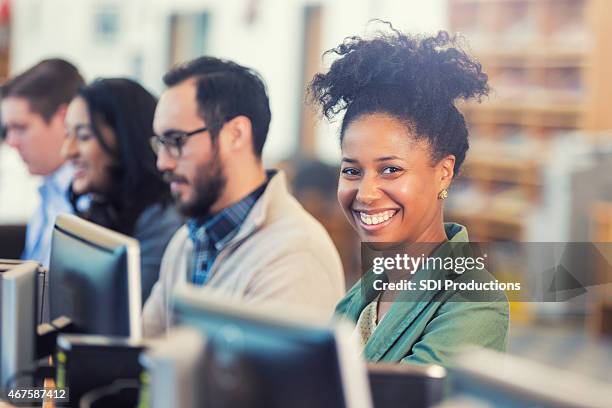 happy african american woman continuing college education or job training - corporate training bildbanksfoton och bilder