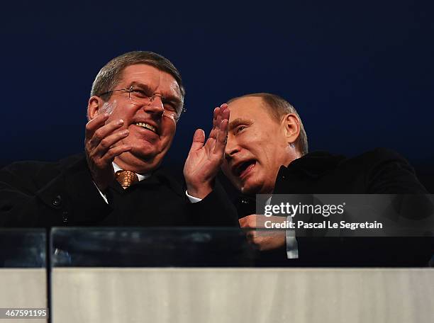 International Olympic Committee President Thomas Bach and Russian President Vladimir Putin enjoy the atmosphere during the Opening Ceremony of the...