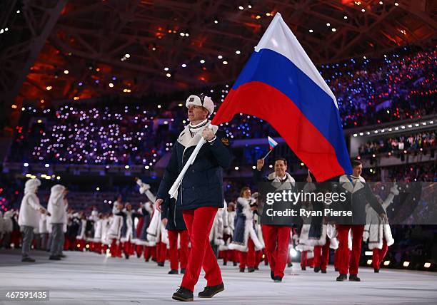 Bobsleigh racer Alexander Zubkov of the Russia Olympic team carries his country's flag during the Opening Ceremony of the Sochi 2014 Winter Olympics...