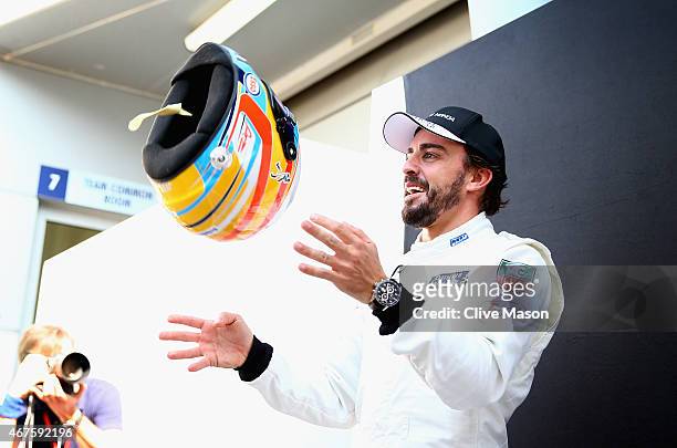 Fernando Alonso of Spain and McLaren Honda poses for photographers outside the team garage during previews to the Malaysia Formula One Grand Prix at...