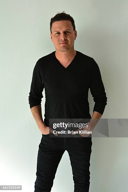 Designer Sergio Davila poses backstage after the Sergio Davila presentation during Mercedes-Benz Fashion Week Fall 2014 at Rogue Space on February 7,...