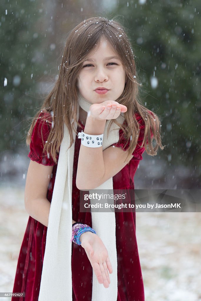Girl Blows Kisses in the Falling Snow