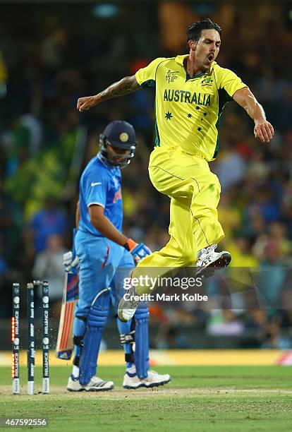 Mitchell Johnson of Australia celebrates after taking the wicket of Rohit Sharma of India during the 2015 Cricket World Cup Semi Final match between...