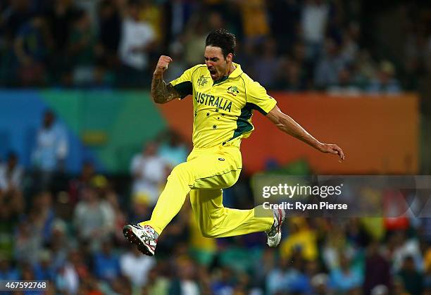 Mitchell Johnson of Australia celebrates after taking the wicket of Rohit Sharma of India during the 2015 Cricket World Cup Semi Final match between...