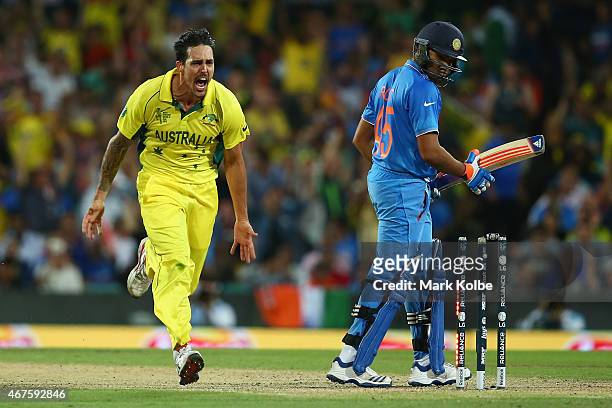 Mitchell Johnson of Australia celebrates after taking the wicket of Rohit Sharma of India during the 2015 Cricket World Cup Semi Final match between...
