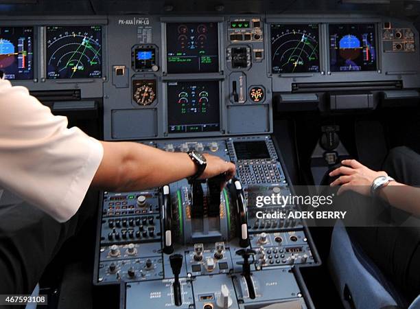 Photo taken on September 24, 2008 shows pilots in the cockpit of an Airbus A320 at Cengkareng airport in Jakarta. One of the two pilots on the...