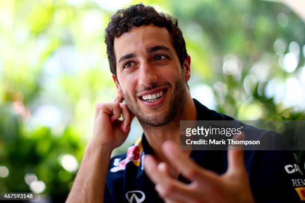 Daniel Ricciardo of Australia and Infiniti Red Bull Racing speaks with members of the media in the paddock during previews to the Malaysia Formula...