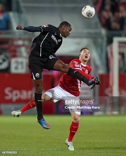 Erik Jendrisek of Cottbus and Seyi Olajengbesi of Sandhausen jump for a header during the Second Bundesliga match between FC Energie Cottbus and SV...